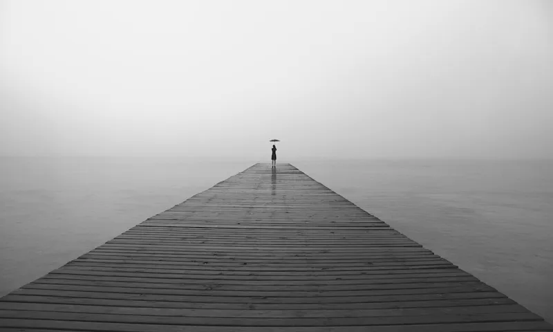 woman with black umbrella looking infinity in a surreal place