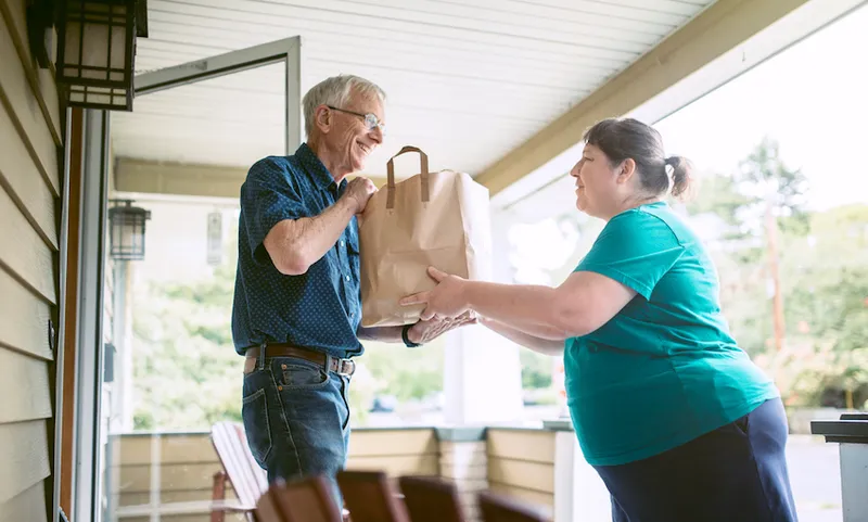 Delivering Groceries To Senior Man