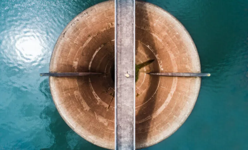 Aerial view of man walking on bridge.