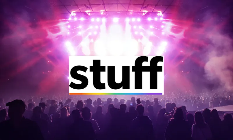 silhouettes of concert crowd in front of bright stage lights