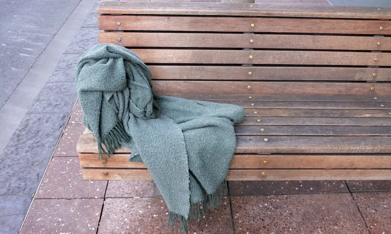 Homeless Person Blanket on a street  Bench