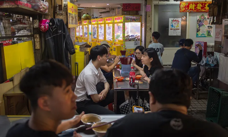 People having street food in a night market with no social