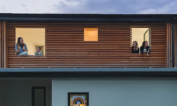 Family clapping to show support from their home