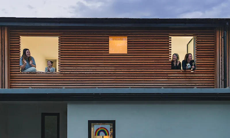 Family clapping to show support from their home