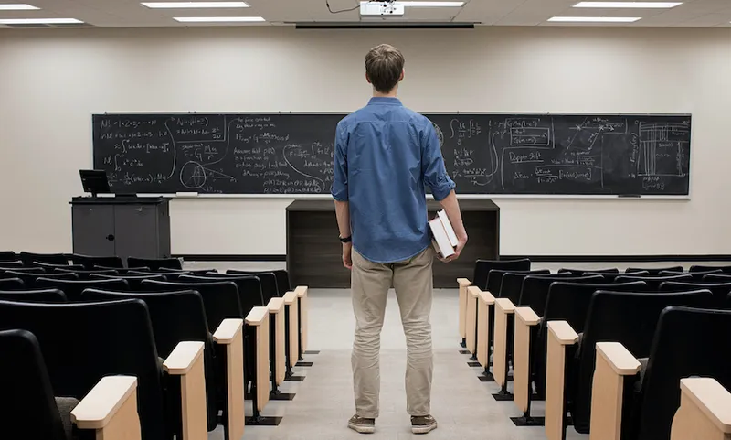 Caucasian student standing in classroom