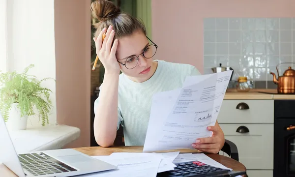 Indoor shot of young European Caucasian girl looking at financia
