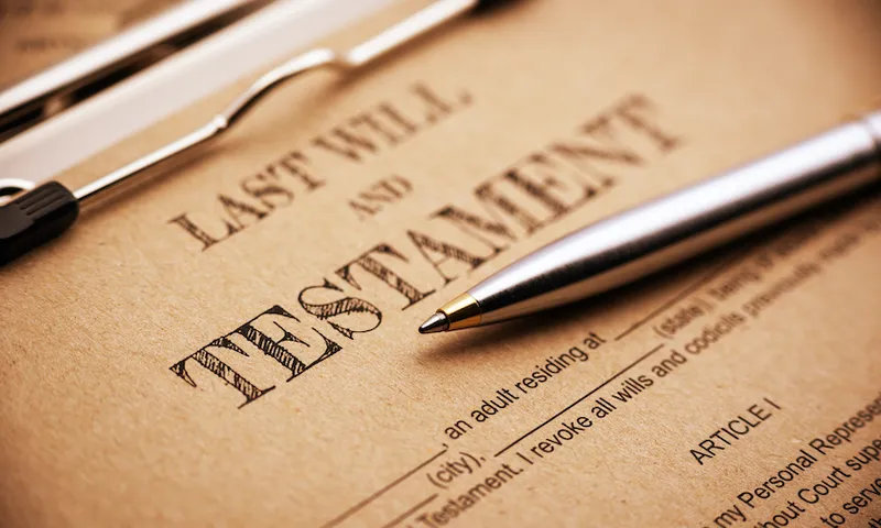 Blue ballpoint pen and a last will and testament.