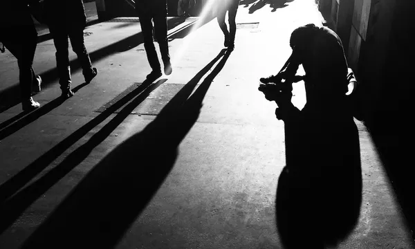 Conceptual Silhouette Of Person Begging On Street