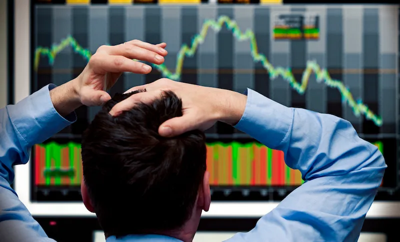 Trader watching stocks crash on screen