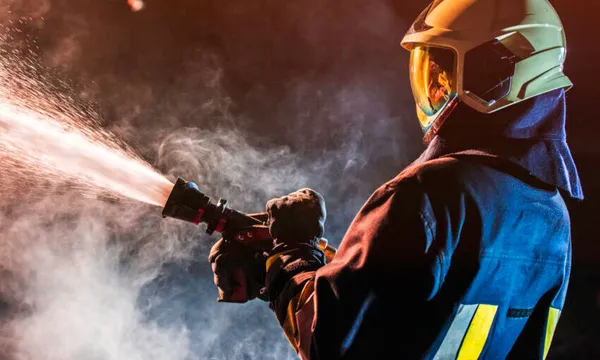 Fireman operating a water fire hose