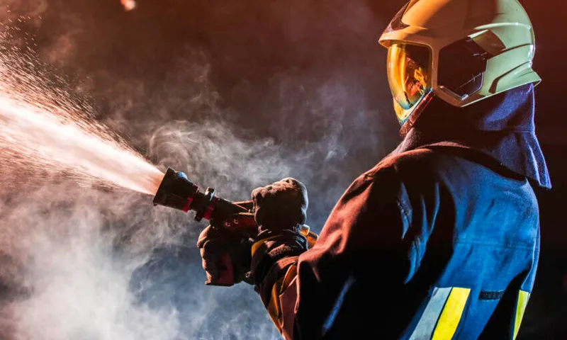 Fireman operating a water fire hose
