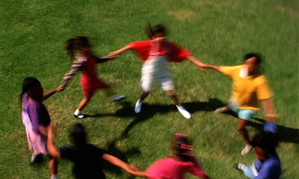 Group of girls (8-10) holding hands in circle, elevated view
