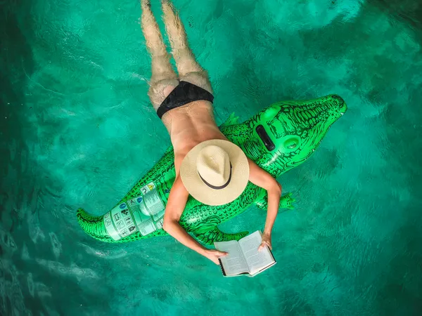 Woman in pool reading