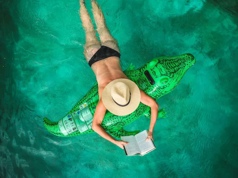 Woman in pool reading