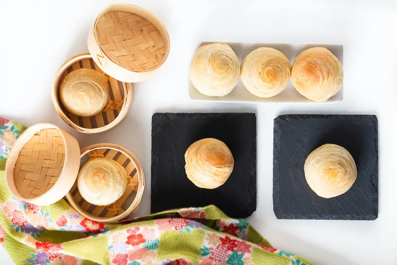 Oriental food concept homemade organic Huaiyang Spiral Chinese flaky  pastry moon cake on white background with copy space