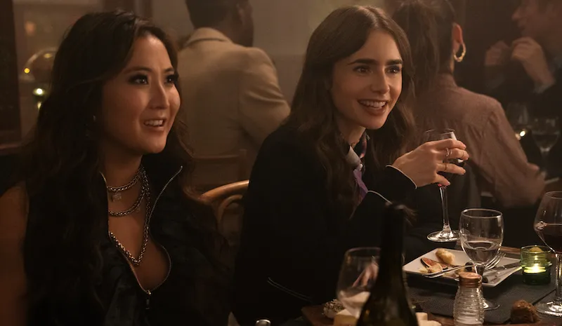 EMILY IN PARIS (L to R) ASHLEY PARK as MINDY and LILY COLLINS as EMILY in episode 107 of EMILY IN PARIS Cr. STEPHANIE...