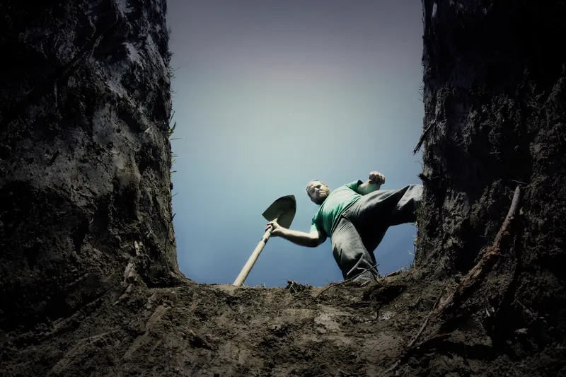 Man looking into a grave