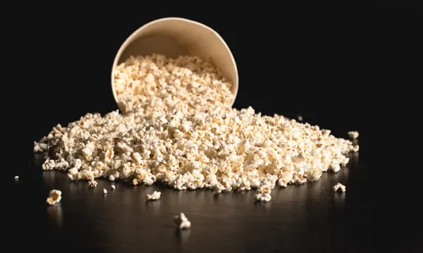 popcorn spilled from cardboard bucket