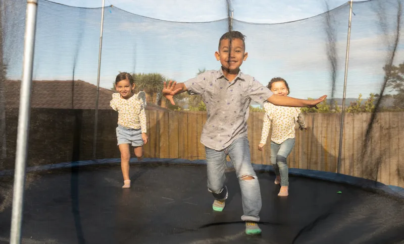 Siblings having fun on trampoline