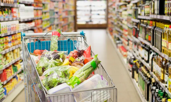 Close up of full shopping cart in grocery store