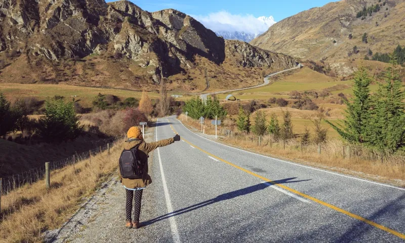 woman with backpack hitch hiking. New Zealand