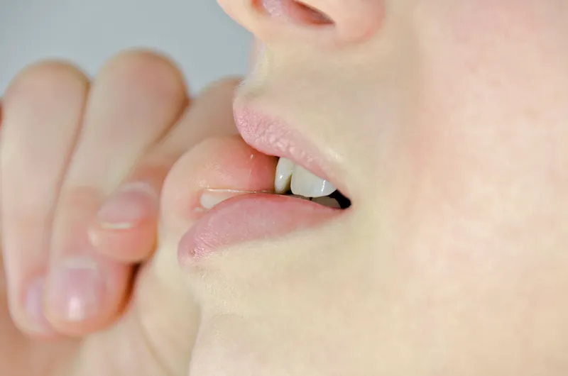 A girl with a habit of biting her nails