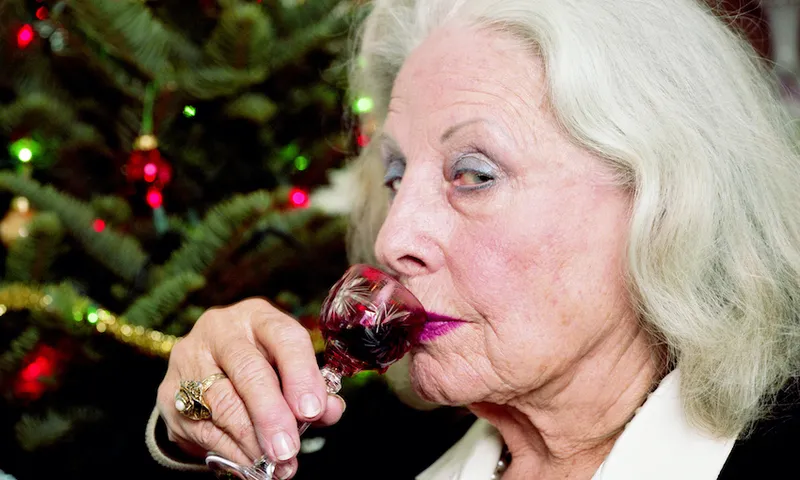 Mature woman drinking liquer from small glass