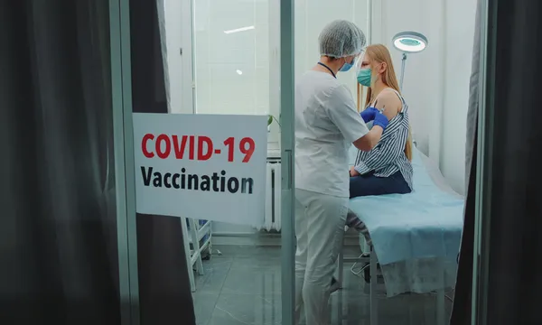 Doctor Injecting Syringe To Woman