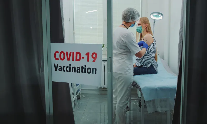 Doctor Injecting Syringe To Woman