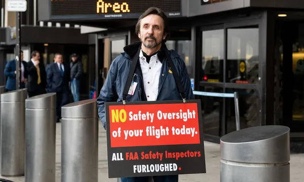 Protester seen outside a press conference in Terminal B at