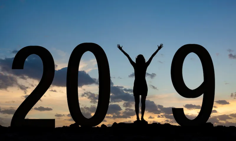 Woman enjoying on the hill and 2019 years while celebrating new year