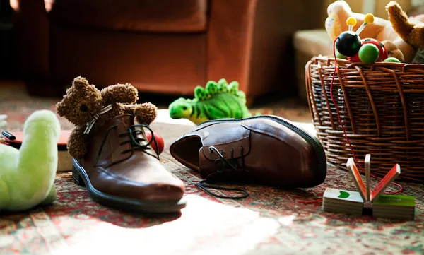 Child’s toys inside adult’s shoes