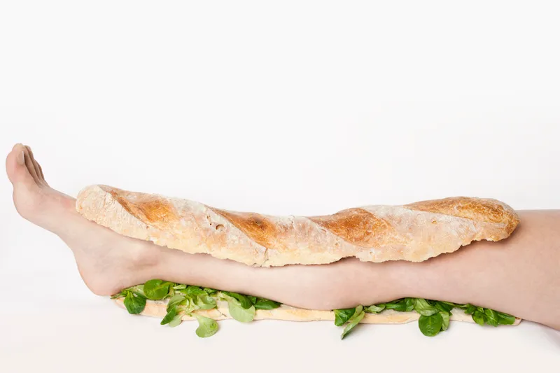 A submarine sandwich with a human leg in it