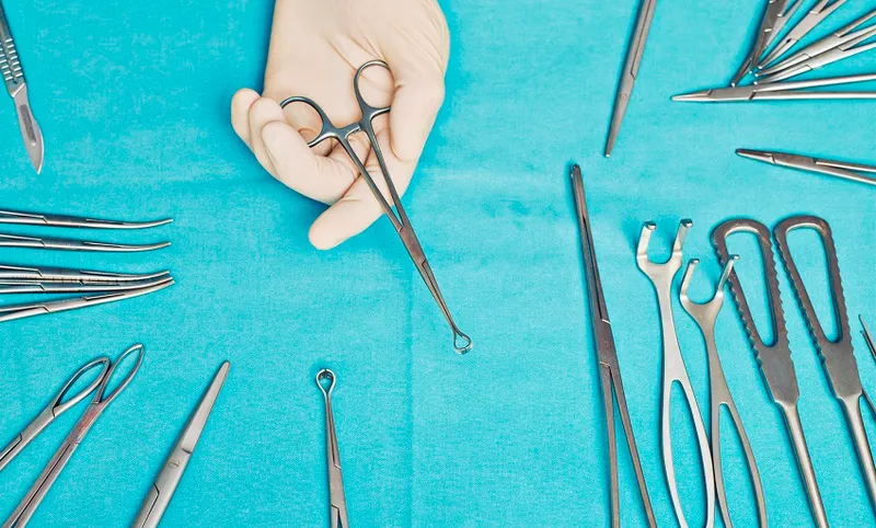Doctor holding clamp