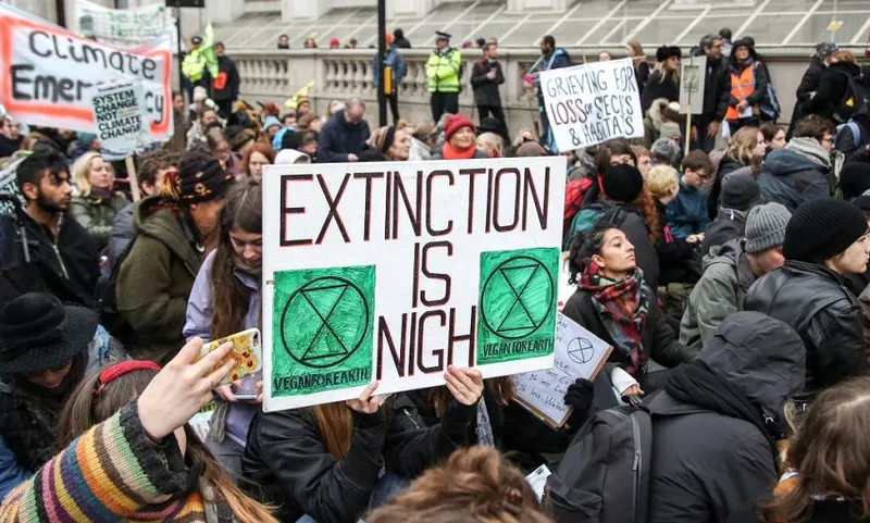 A climate change activist seen holding a placard during the