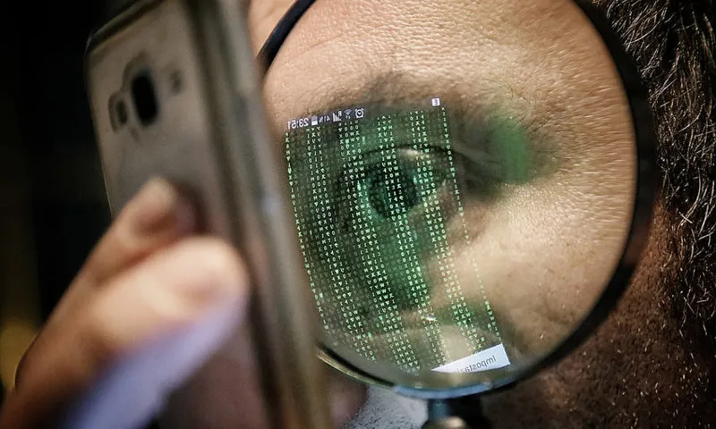 Cropped Image Of Man Looking At Mobile Phone Through Magnifying Glass