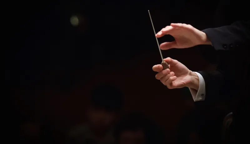 Cropped Image Of Conductor In Orchestra