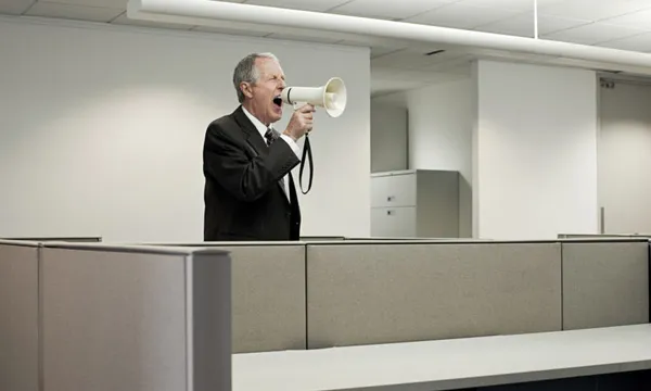 Businessman shouting through megaphone