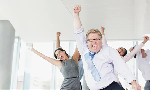 Businesspeople dancing in office