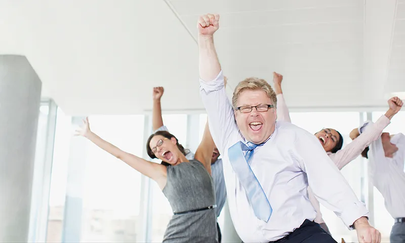 Businesspeople dancing in office