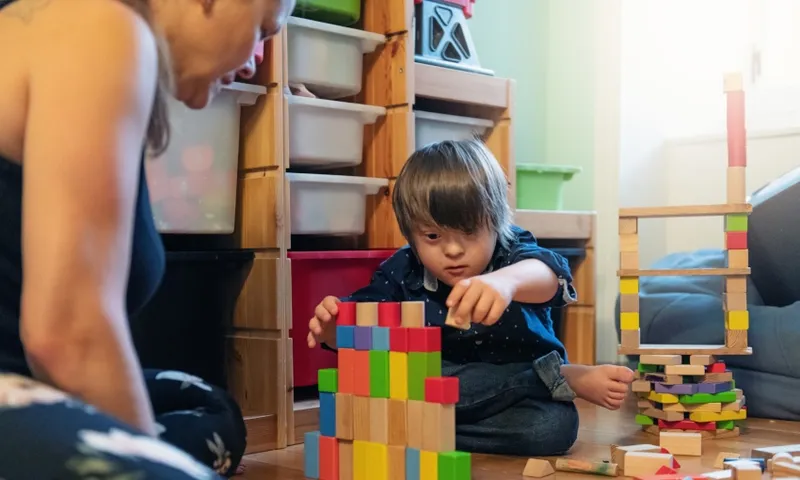 child with intellectual disability playing with blocks getty