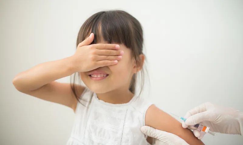 Cropped Image Of Doctor Injecting Girl In Hospital