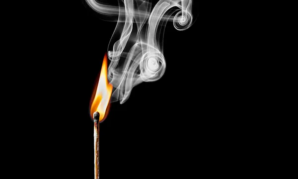 Close-Up Of Burning Matchstick Against Black Background