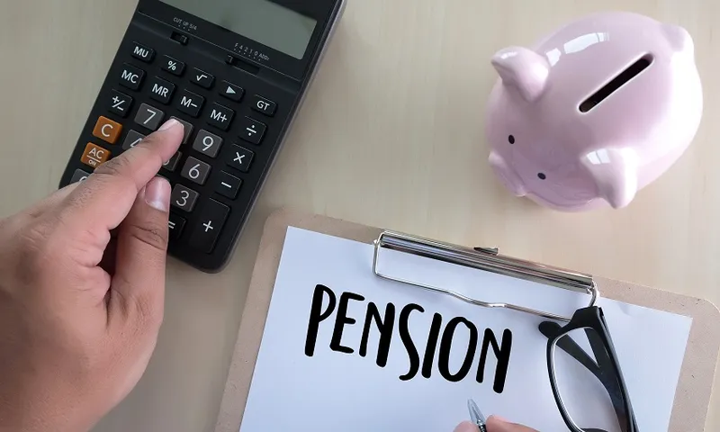 Cropped Hand Using Calculator With Document At Table