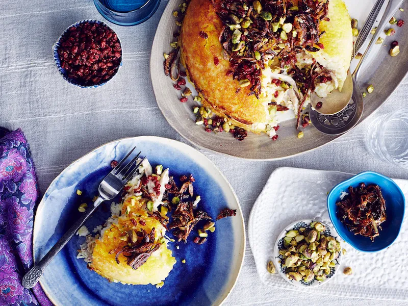 Still life of Iranian tahchin with rice, chicken and yogurt