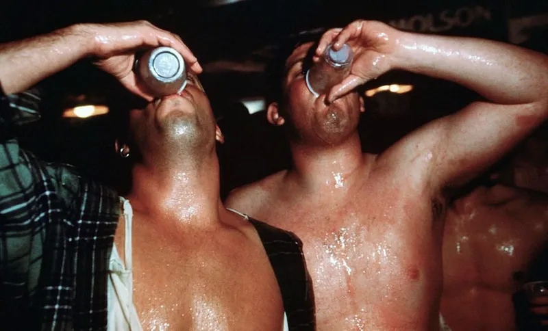 Two Men Binge Drinking at a Party