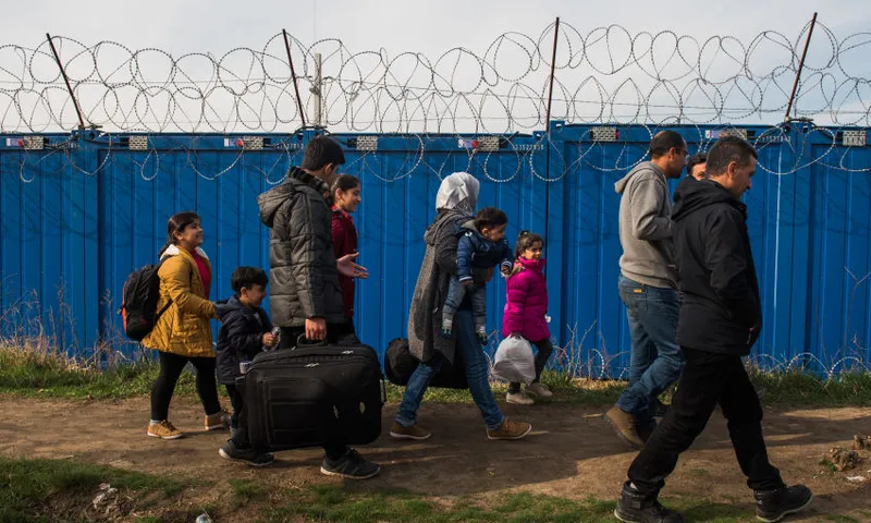 A family of Syrian refugees walking at the border between Serbia and Hungary Getty Images Omar Marques resized