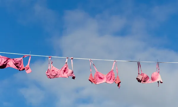 Low Angle View Of Bras Hanging On Clothesline Against Sky