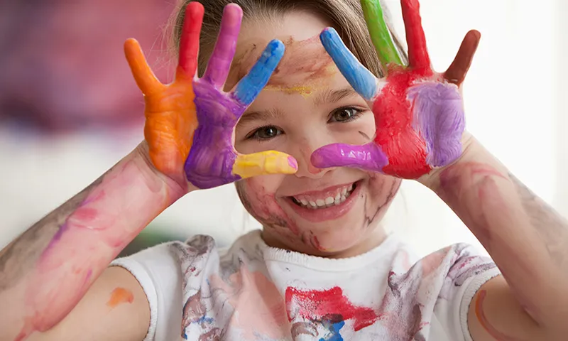 Messy Caucasian girl in art class