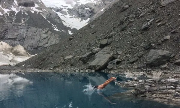 Nick Atkinson swimming in a nameless alpine lake Photo by Finn Scholes